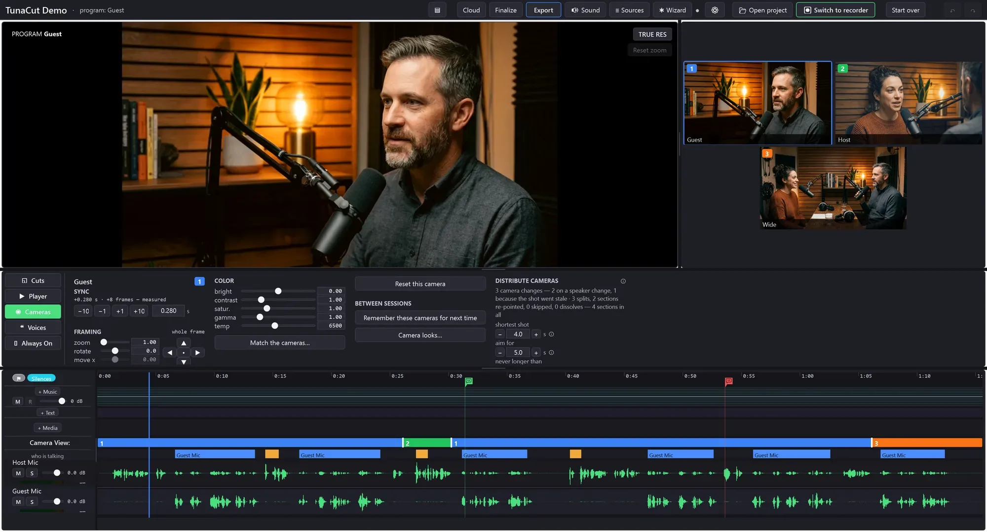 The TunaCut editor: program monitor, three camera tiles, the camera panel and a timeline with the camera-view bar, speaker ribbon and two waveform lanes